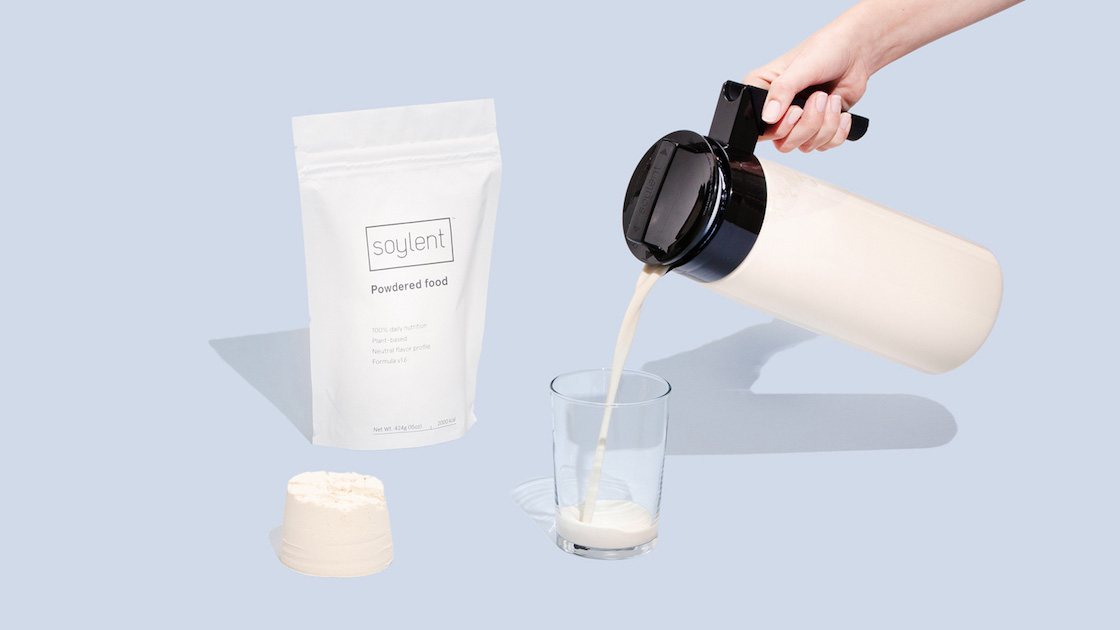 Soylent powder bag, pitcher and glass with Soylent being poured into it.